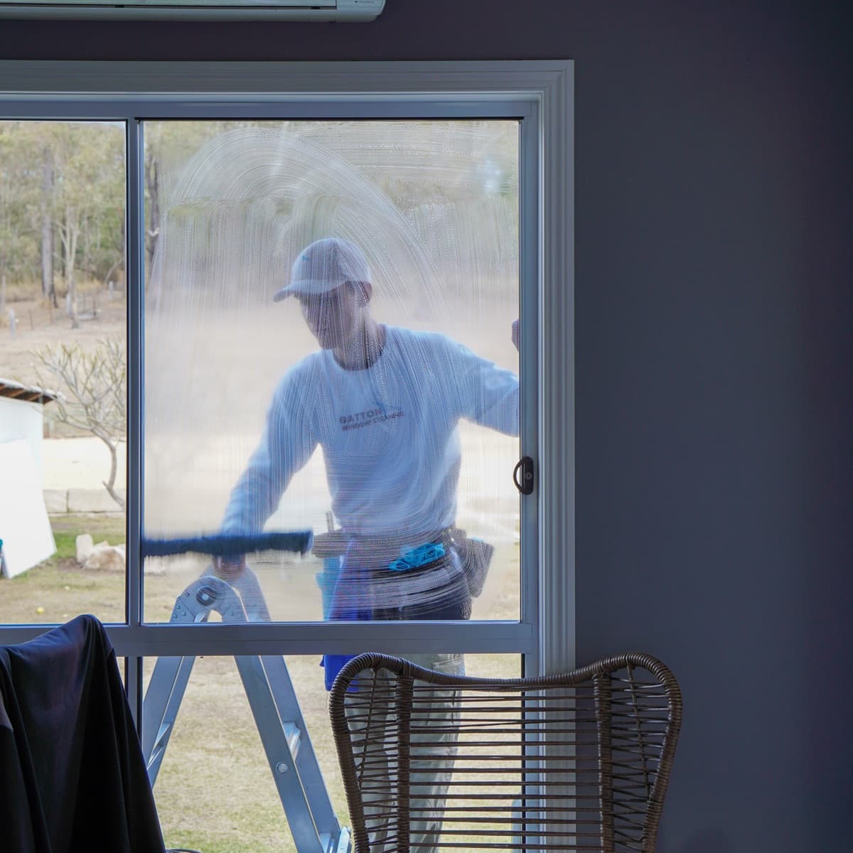 Squeegee work seen through the glass at an acreage home