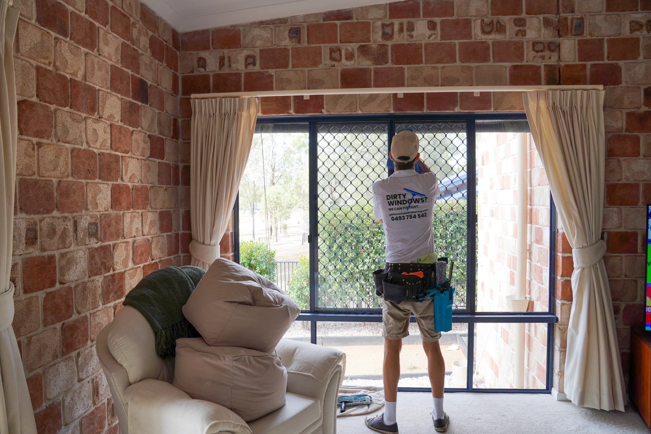 Sliding doors detailed in a brick sunroom lounge