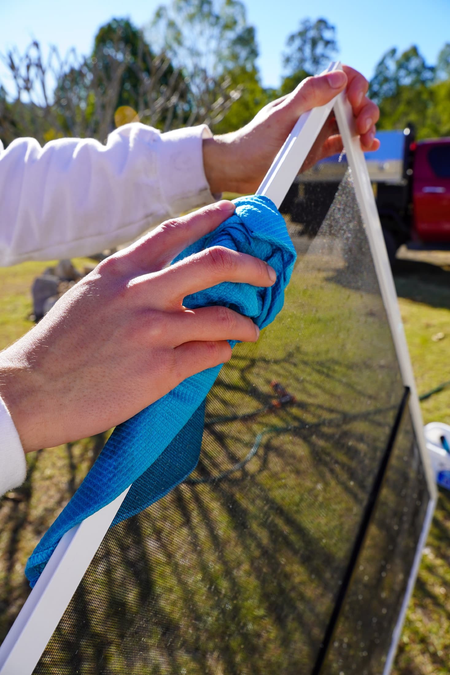 Zoomed in on a fly screen getting hand-detailed